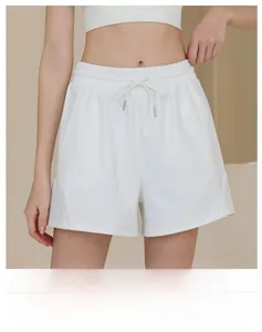 Macro detail of white high-waisted nylon sports shorts with drawstring and elastic waistband