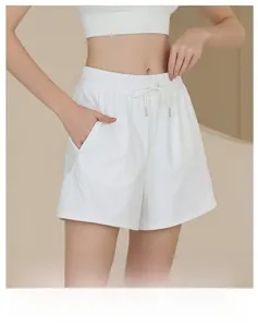 Close-up of white nylon sports shorts featuring elastic drawstring waist and side pockets