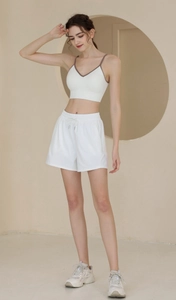 Detailed close-up of high-waist nylon sports shorts with elastic drawstring waist detail