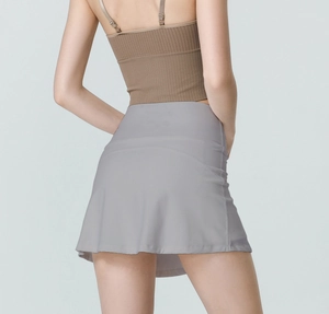 Back view of high waisted light grey athletic skirt featuring anti-exposure inner lining