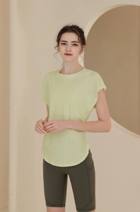 Detail view of the flutter sleeve and curved hem on this lime green athletic yoga t-shirt