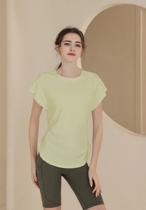 Detail of breathable mint green fitness t-shirt and olive green cycling shorts on model