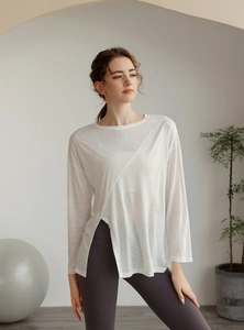 Détail du haut de yoga blanc avec fente frontale et épissure diagonale élégante