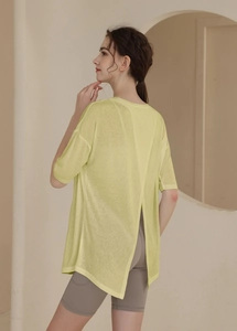 Detail of light yellow yoga t-shirt with open crossover back design and thin airy fabric