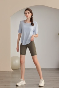 Slim fit yoga top featuring a unique diagonal cutout neckline and premium tencel fabric
