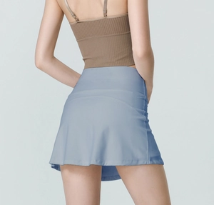 Detail view of high-waist athletic skort in mist blue with flared A-line silhouette