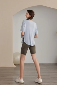 Detail view of Tencel yoga top with side slit and high waist cycling shorts outfit