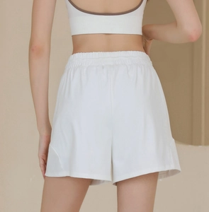 Rear view of white high-waisted nylon sports shorts with elastic waist and wide-leg design