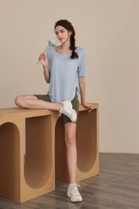 Detail of light blue yoga t-shirt featuring unique hollow neckline and breathable fabric
