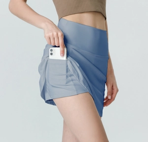 Detail of grey-blue athletic skort showing the built-in phone pocket and inner shorts