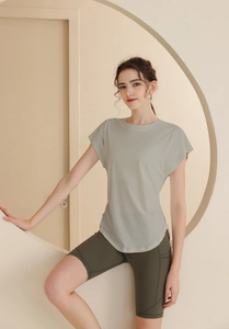 Detail of light gray short sleeve gym top and olive green cycling shorts with side pockets