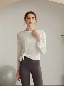 Détail d'un haut de yoga blanc semi-transparent à manches longues avec cordon de serrage