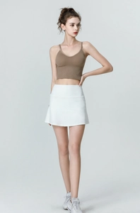 Detail of high-waisted white tennis skirt with elastic fabric for running and gym
