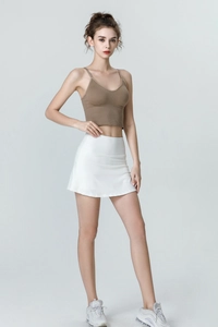 Close-up of high-waisted white athletic tennis skirt with breathable fabric details