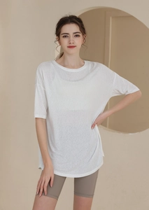 Detail of loose fit white t-shirt and grey cycling shorts for summer sports