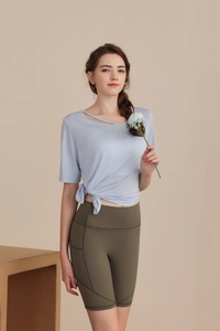 Detail view of Tencel yoga top with hollow neckline and side tie knot decoration