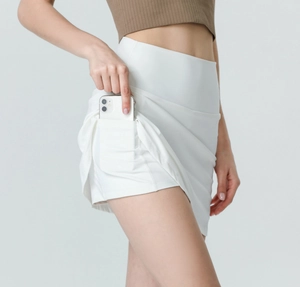 Detail of white high-waisted tennis skirt showing hidden inner pocket for phone storage