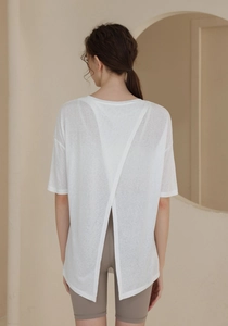 Detail of white semi-transparent sports top with V-shaped open back split design