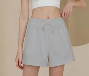 Detail of grey athletic shorts with elastic drawstring waist and knit fabric texture