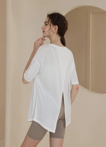 Detail view of white open back t-shirt showing criss-cross split for fitness and yoga