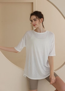 Detailed texture of white loose-fit breathable t-shirt for running and yoga