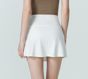 High-waisted white tennis skirt with A-line design and ergonomic seams on the back view