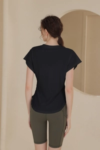 Rear view of women's breathable black sports t-shirt and olive green cycling shorts