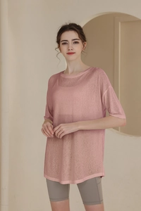 Detail of pink loose-fit sports T-shirt featuring breathable translucent fabric texture