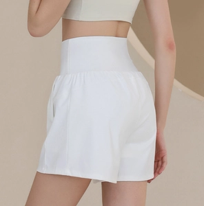 Detail view of white high-waisted nylon sports shorts with wide supportive waistband
