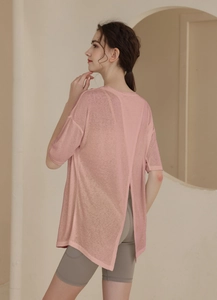 Back view of pink split-back sports t-shirt and grey high-waist yoga shorts with pockets