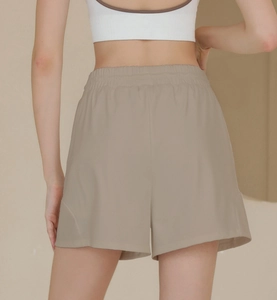 Detailed back view of high-waisted nylon sports shorts with elastic waistband in khaki