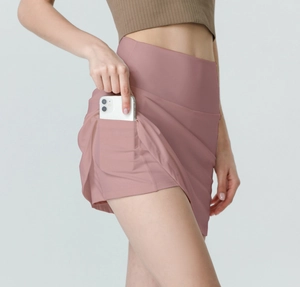 Detail of high-waist athletic skort showing side pocket with a smartphone inside