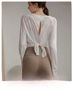 Detail view of breathable yoga long sleeve with open back and stylish tie-up design