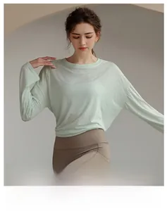 Macro shot of breathable light green Tencel fabric on a women's long-sleeve athletic coverup