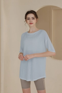 Close-up of a light blue oversized t-shirt in a breathable knit fabric for yoga sports