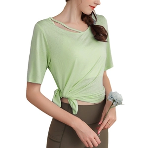 Light green yoga top with shoulder cutout and stylish side knot design for fitness