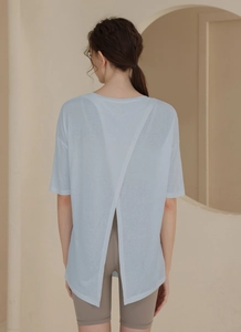 Detail of cross-over back design on a loose fit light blue Tencel yoga t-shirt