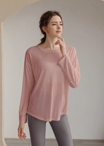 Close-up of lightweight pink Tencel yoga top with loose fit and long sleeves