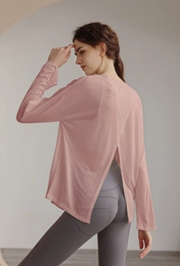 Detail view of pink yoga top with stylish back slit design and breathable texture