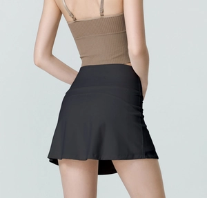 Rear view of black high-waisted tennis skort showing breathable fabric and curved hemline