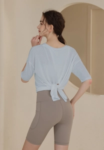 Detail of light blue knotted back sports T-shirt and high waist shorts with side pocket