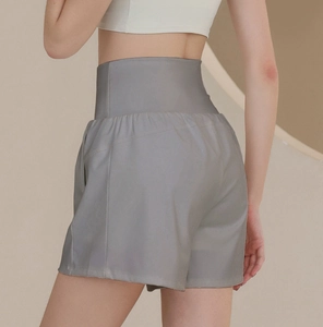 Detailed back view of high-waisted grey sports shorts with loose leg design for women