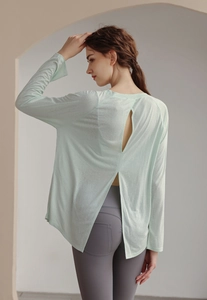Lightweight mint green yoga long sleeve with stylish back slit and v-cut details