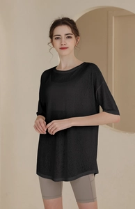Macro detail of breathable black tencel workout top with a loose drop shoulder fit