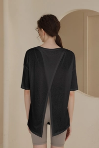 Detail showing women's black yoga t-shirt with unique criss-cross open back design