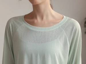Close-up of light green tencel yoga shirt showing breathable fabric texture and neckline