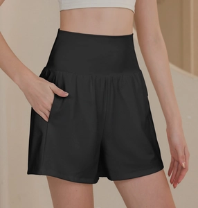 Close-up of black high-waisted nylon sports shorts with side pocket and tummy control design