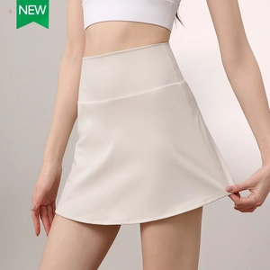 High-waisted athletic cream tennis skirt with inner shorts and built-in side pockets
