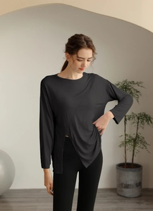 Détail du haut de yoga gris anthracite avec ourlet asymétrique et tissu respirant