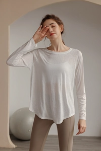 Close-up of lightweight semi-transparent white long sleeve yoga tee with crew neck and loose fit